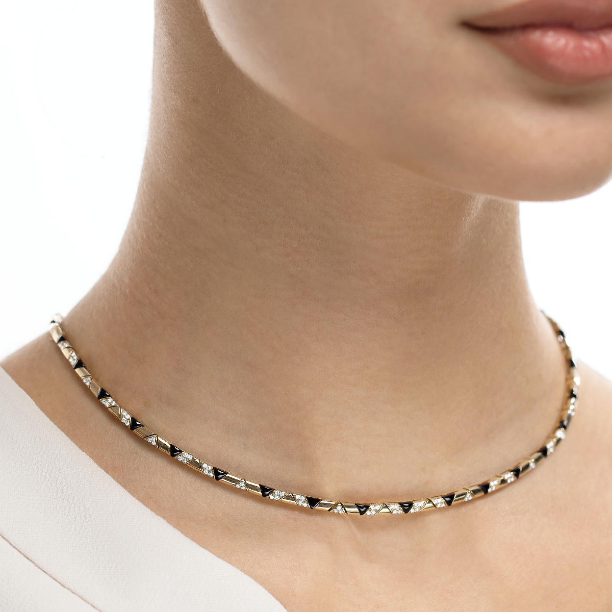 Sadu gold necklace with black onyx and diamonds on a model in white background