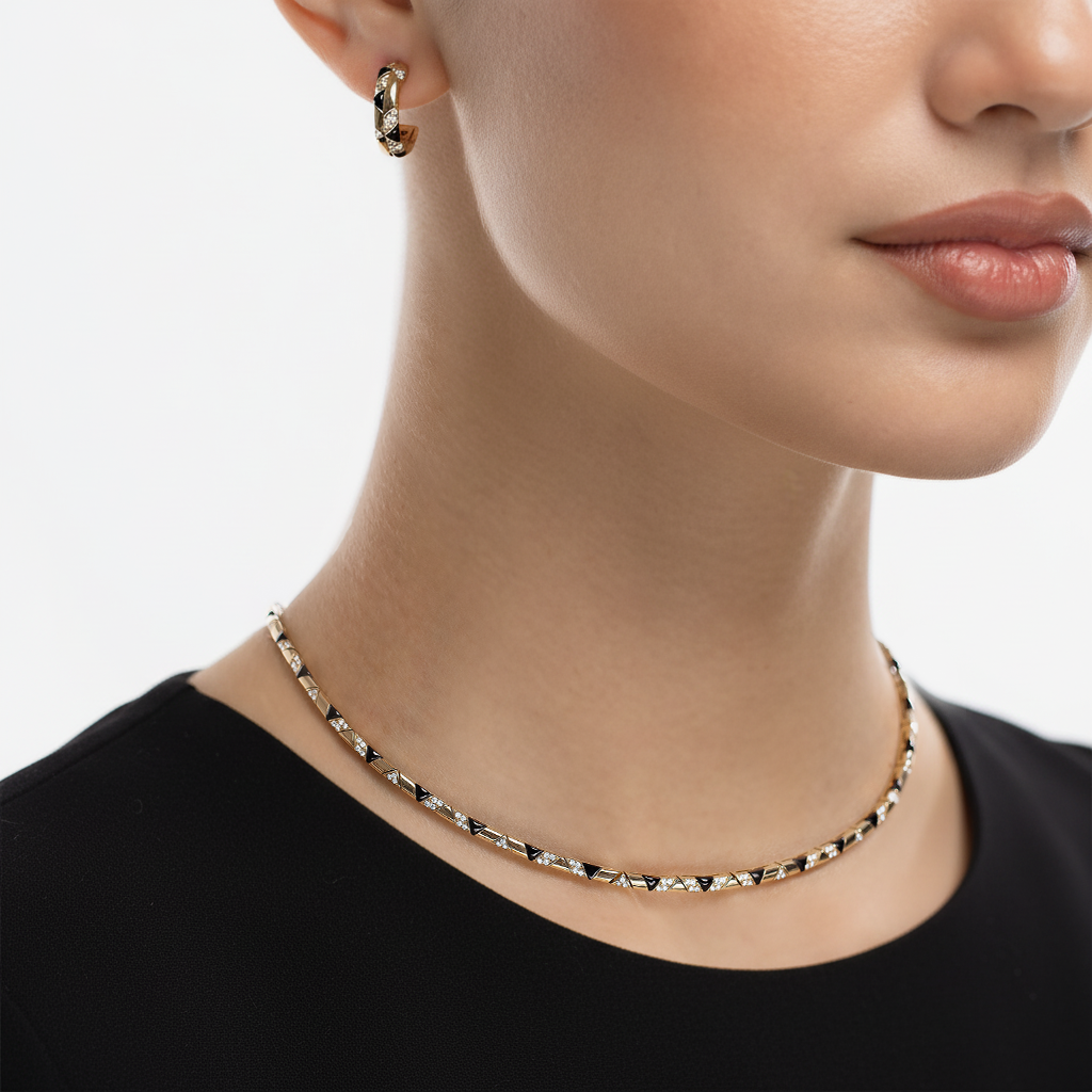 Al Zain Jewellery Sadu Close-up of a person wearing a gold necklace and hoop earrings on a white background